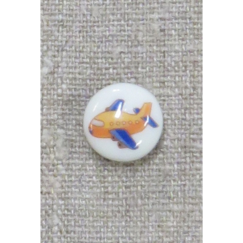 Rund knap i hvid med flyvemaskine